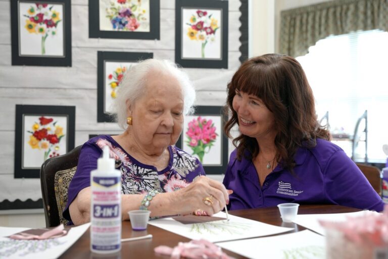 Memory Care Assisted Living resident and employee doing craft