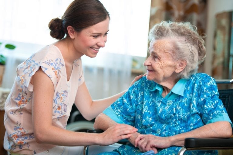 empathetic family caregiver helps an aging loved one