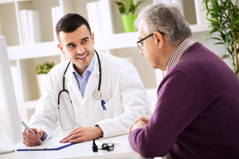 Senior discussing health concerns with his doctor