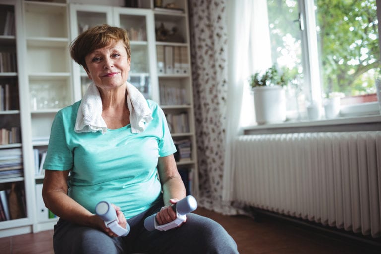 Woman enjoying senior exercise from the comfort of home
