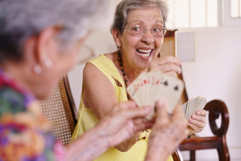 Residents enjoy time together playing cards