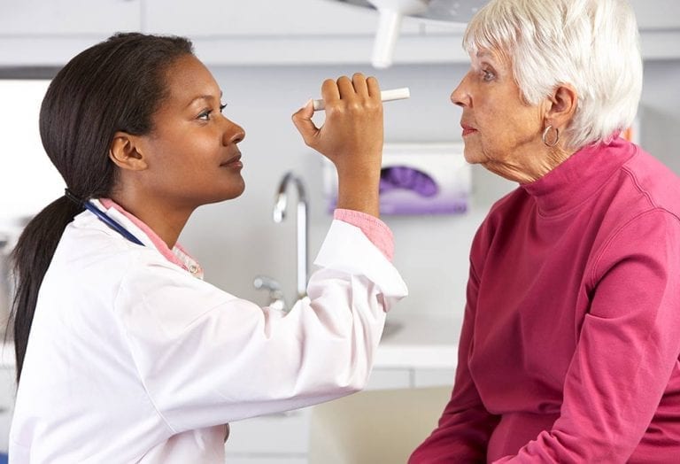 Elderly woman getting her eyes checked