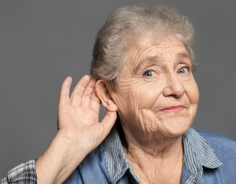Woman holding her ear to listen better