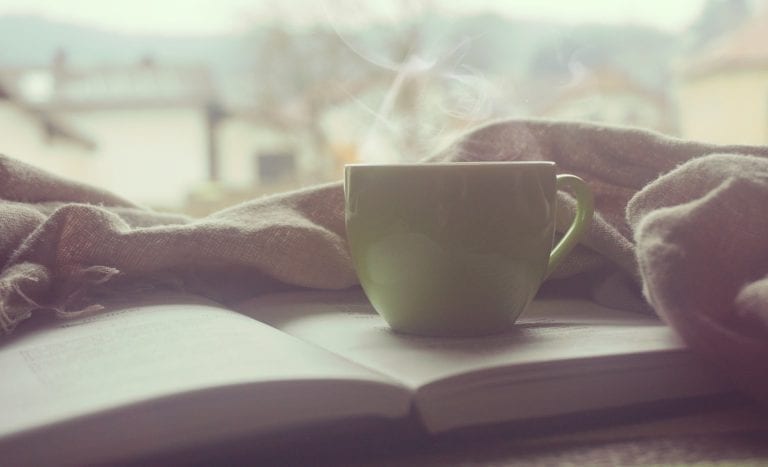 hot cup of coffee and a book