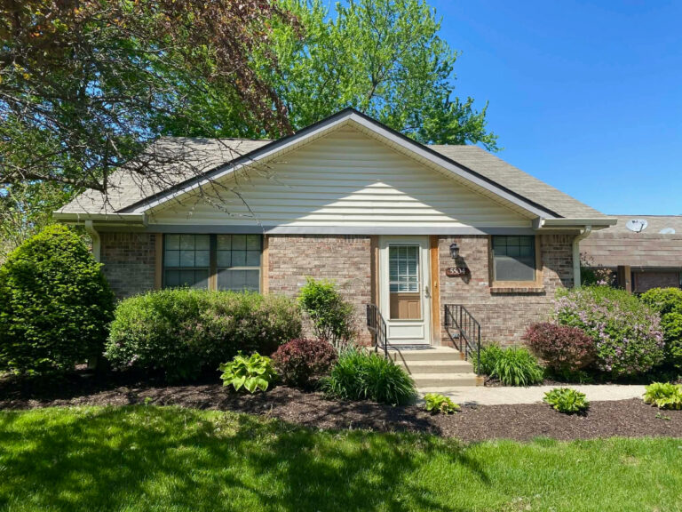 American Village independent living lifestyle image of their beautiful Garden Home in full bloom and greenery