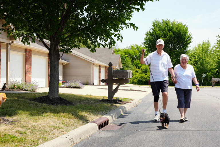 Male and female Garden Home residents walking their dog