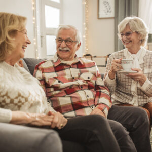 Senior friends smiling together during conversation
